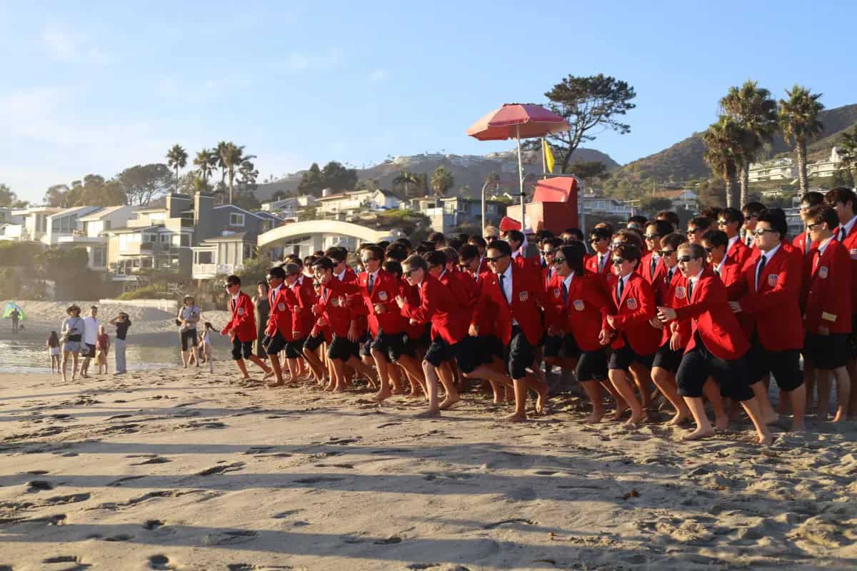 The All-American Boys Chorus sprint toward the ocean as part of their musical exploration of Route 66.