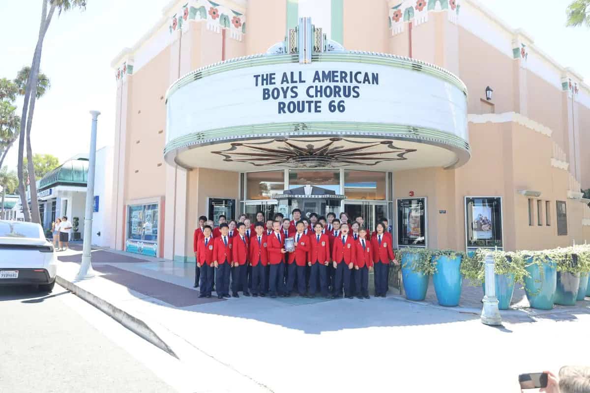 Members of the All-American Boys Chorus stand in front of the Lido Theater.